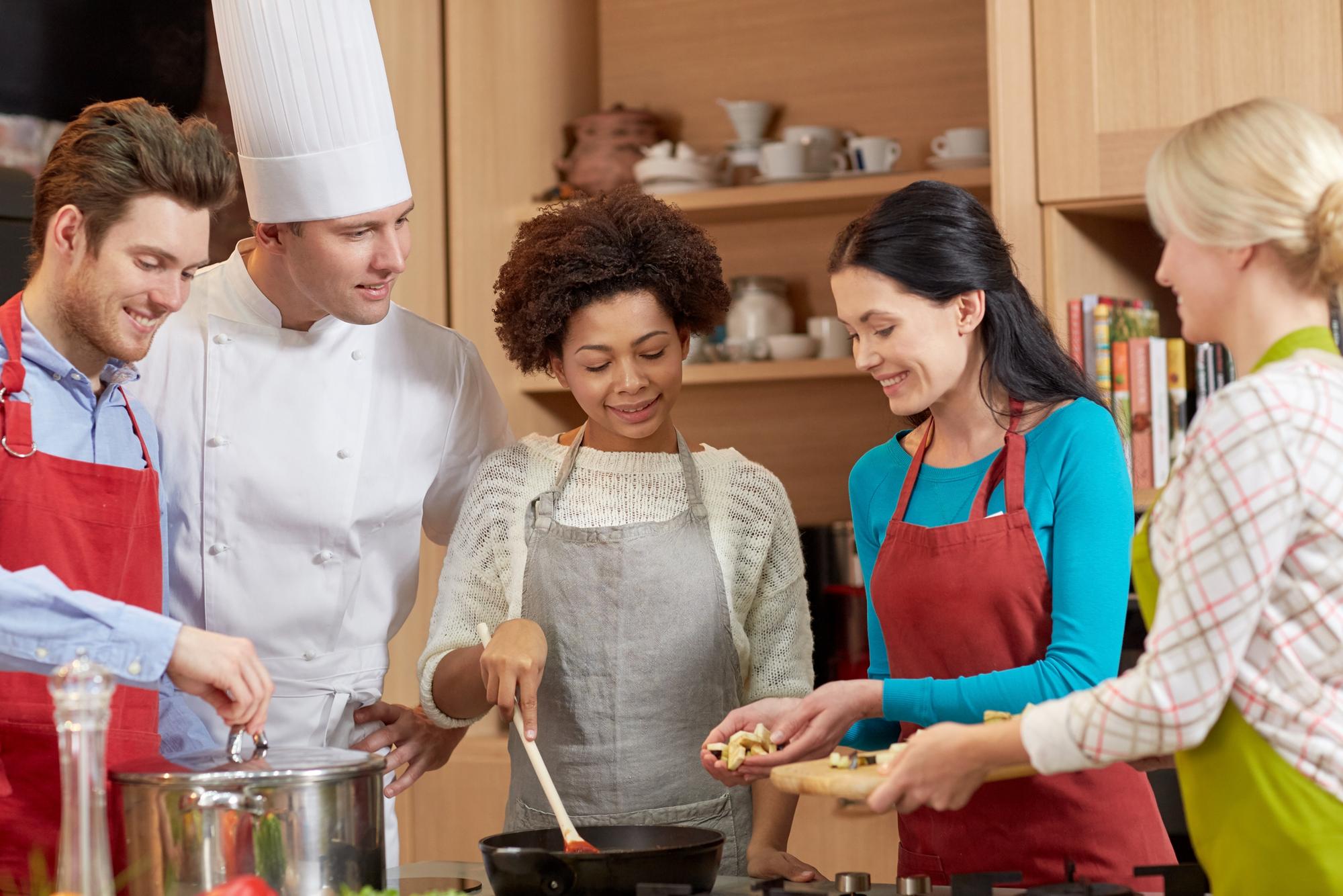 Instructor guiding students in a cozy kitchen