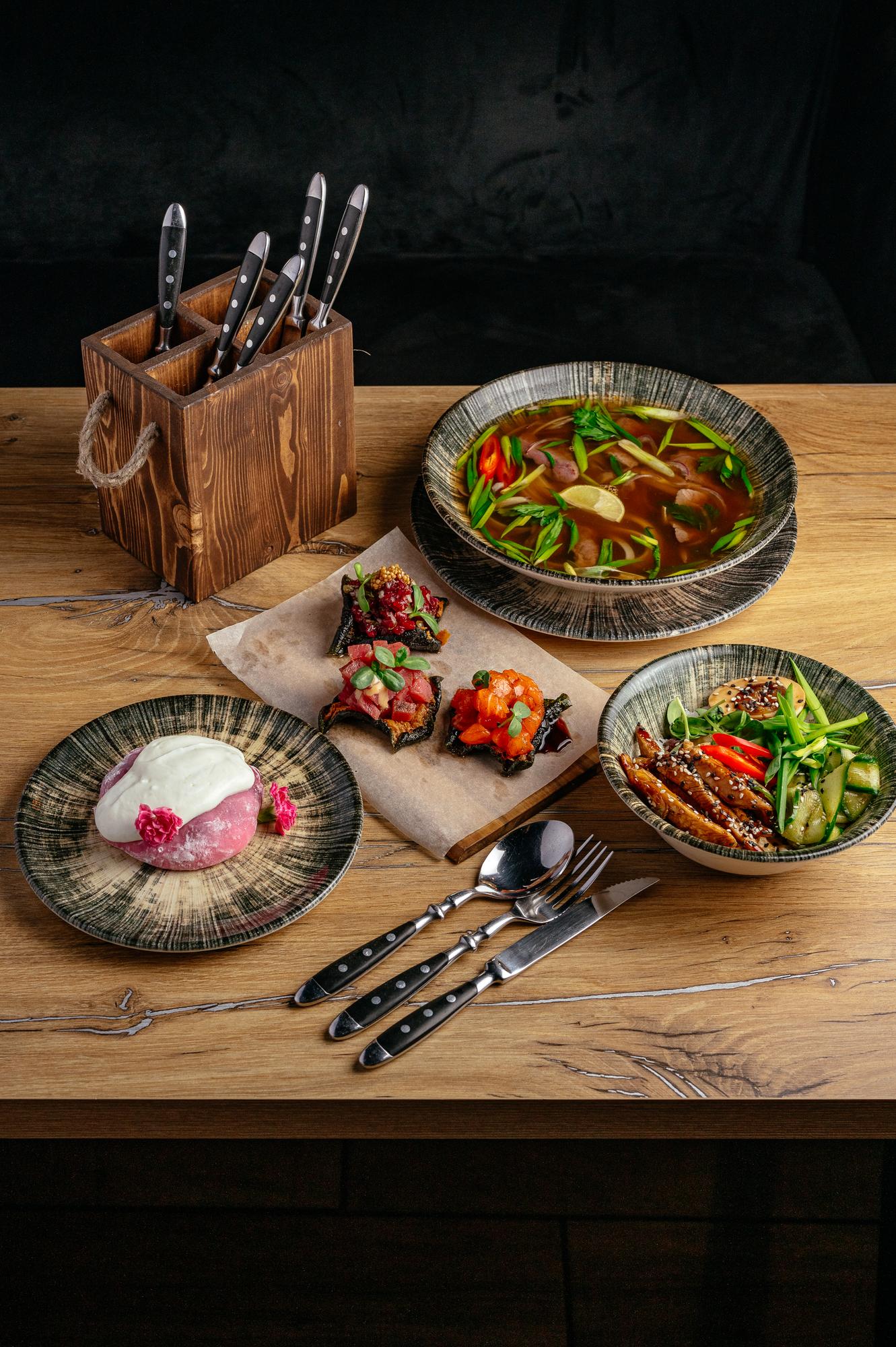Assorted finished dishes on a wooden table